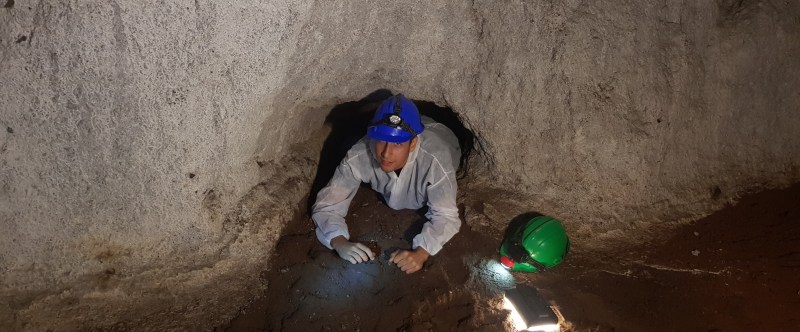 A person passing trough a hole