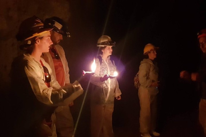 a couple of people that are standing in the dark