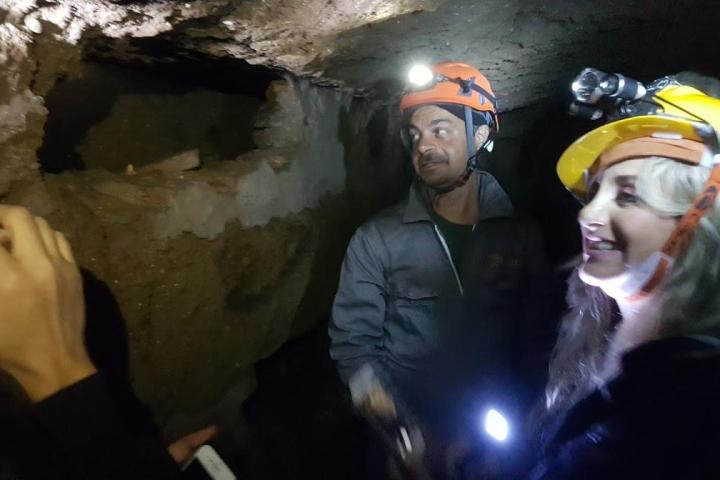 Two persons with lights in the undergrounds