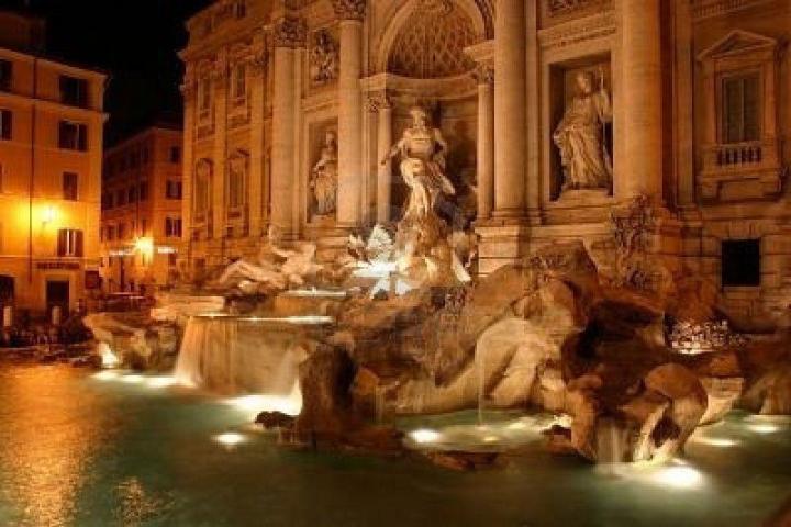 a close up of a water fountain in front of Trevi Fountain