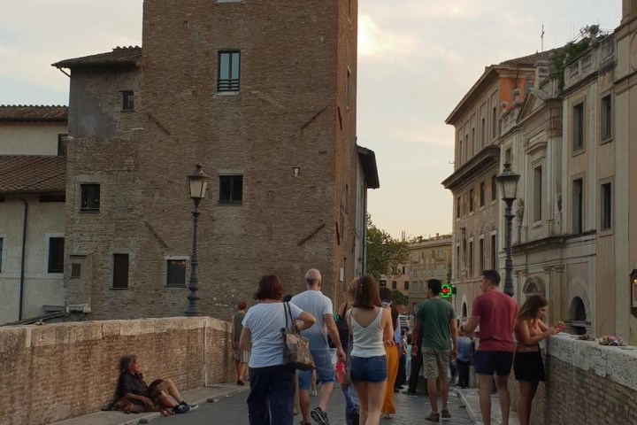 a group of people walking on a brick building